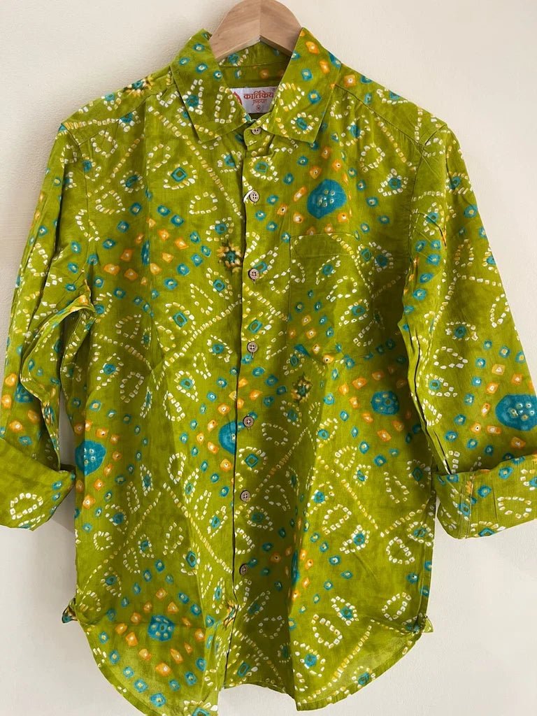 Green patterned shirt on a hanger against a white background