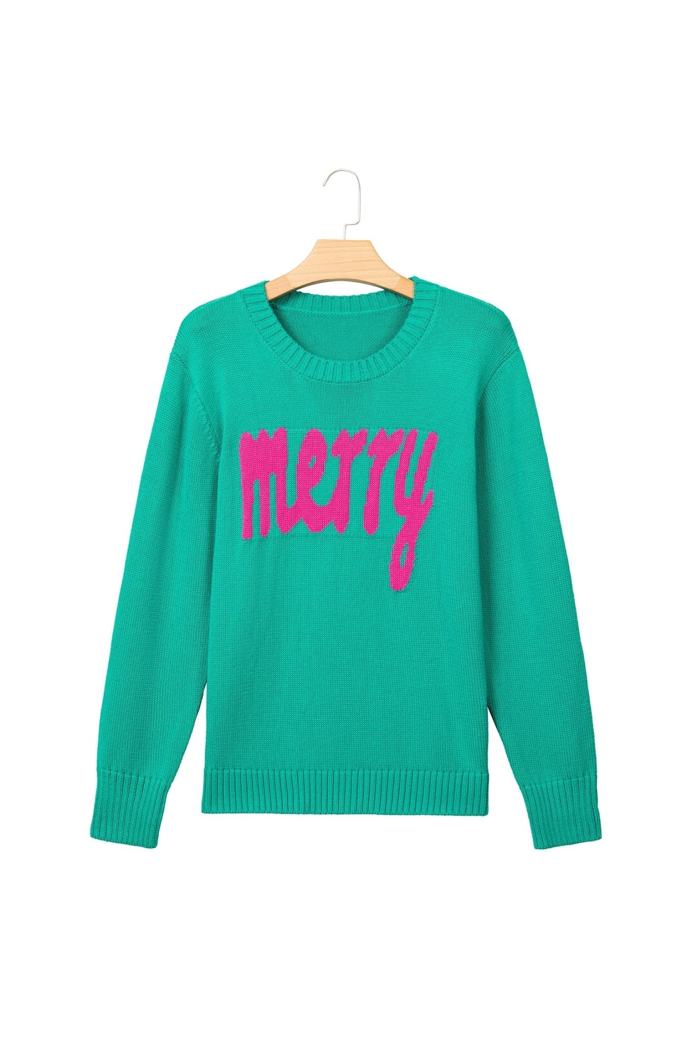 Bright green crewneck sweater with “merry” in pink script, hanging on a wooden hanger against white.