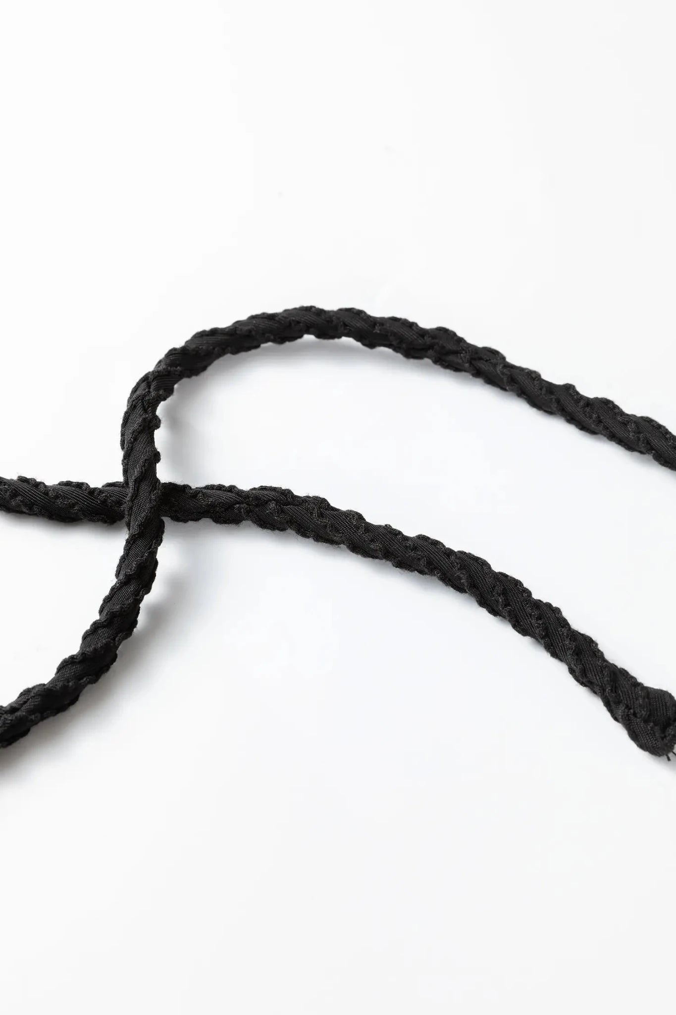 Close-up of black rope on a white background
