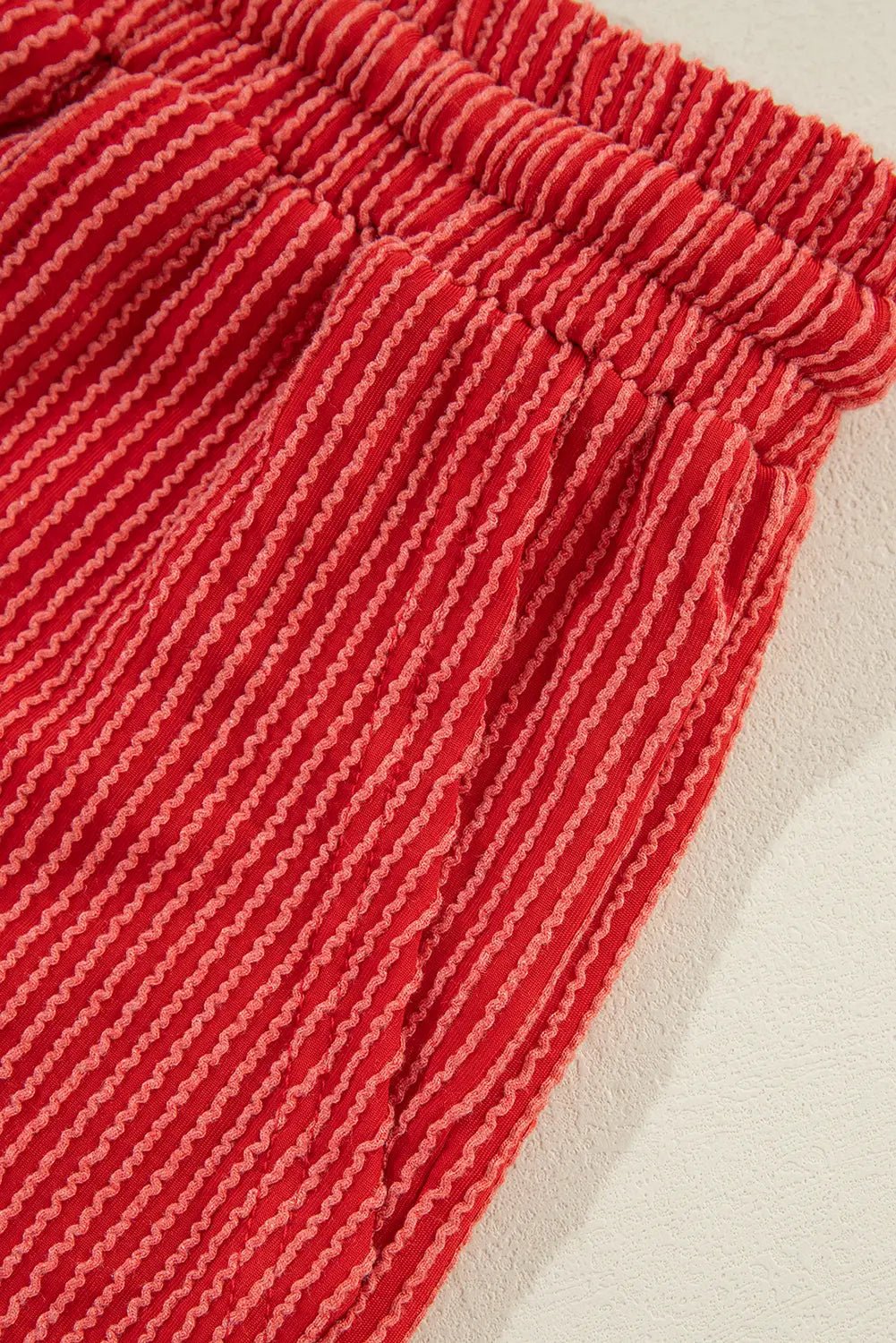 Close-up of red textured fabric on a beige background
