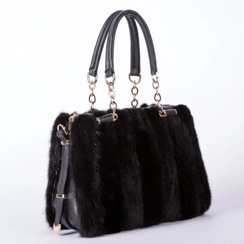Black fur handbag with gold accents on a white background