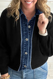 Woman in black ribbed cardigan over a blue denim button-front shirt with light blue jeans against a white brick wall.