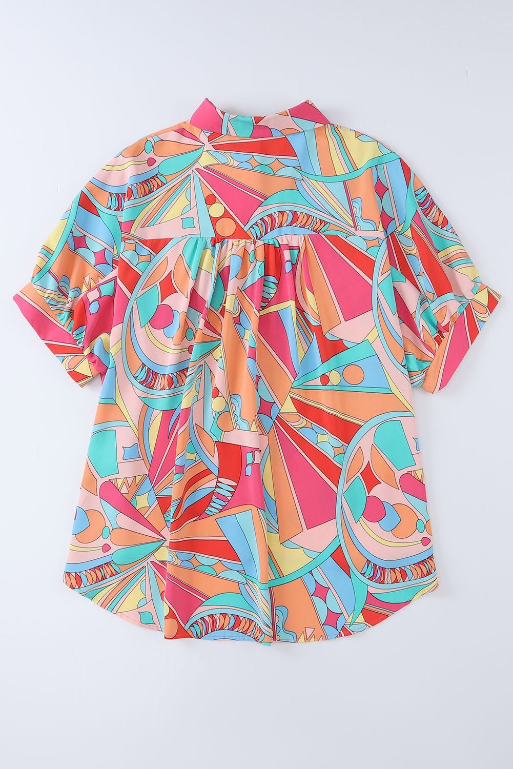 Colorful geometric patterned shirt on a white background