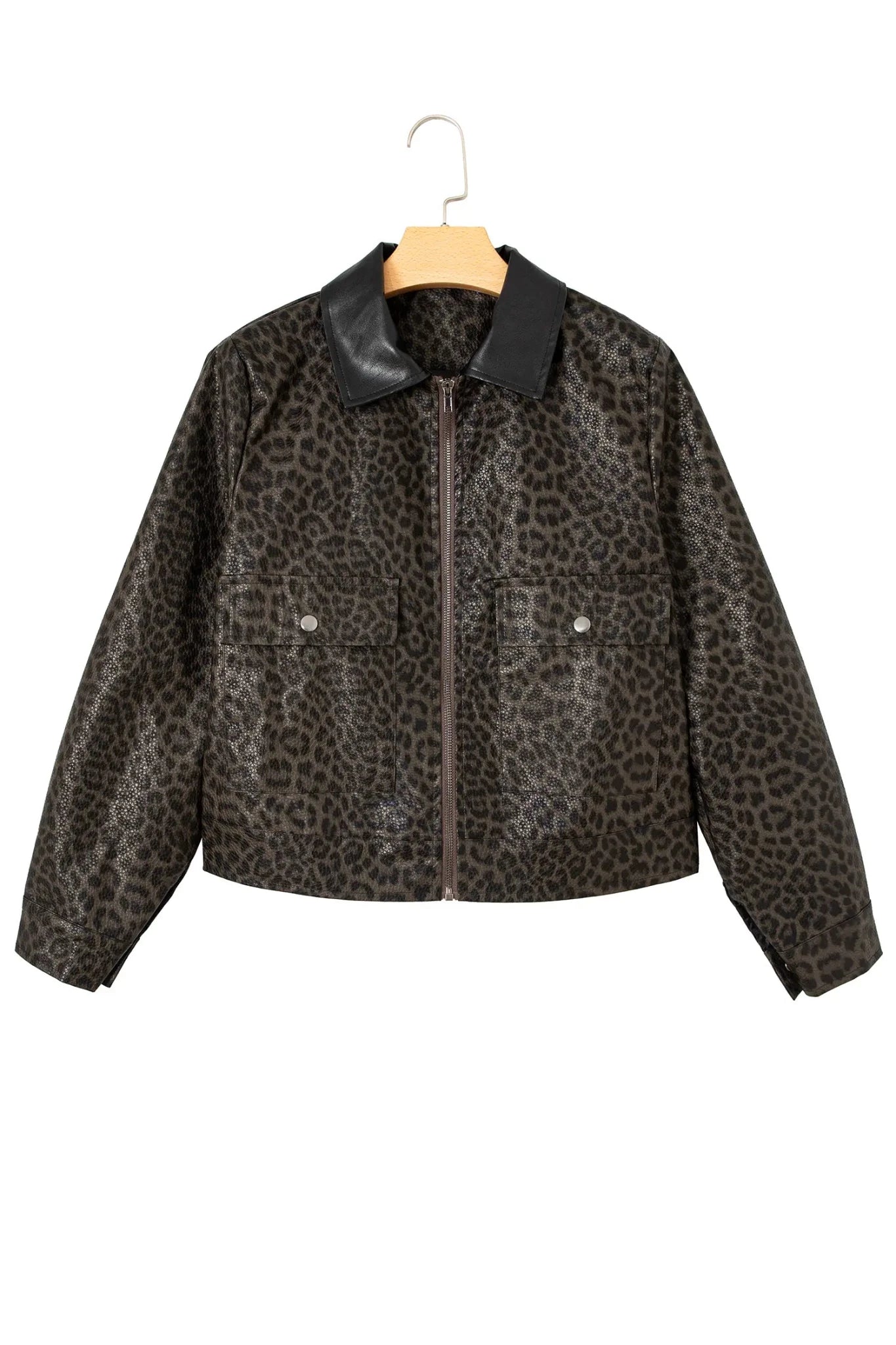 Cropped faux-leather leopard-print jacket with black collar and front zipper hanging on a wooden hanger against white.