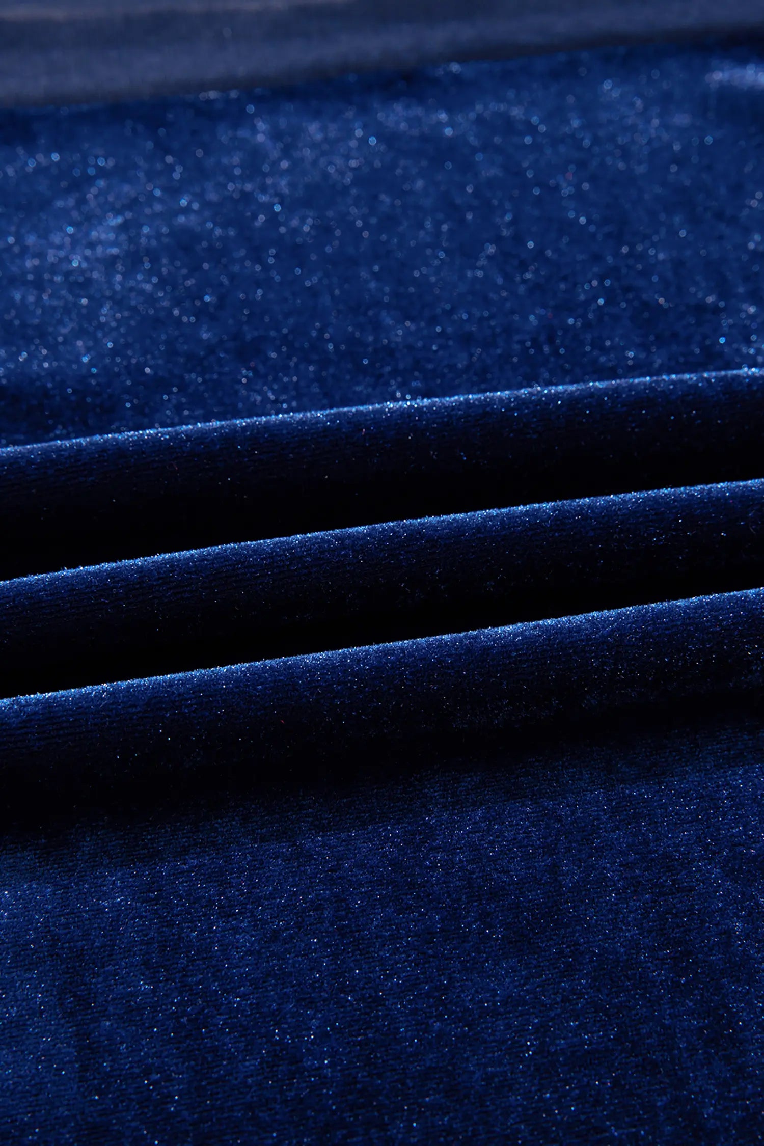 Close-up of soft navy stretch velvet fabric with a subtle sheen