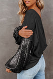 Woman wearing a black sweater with sequin sleeves against a gray background