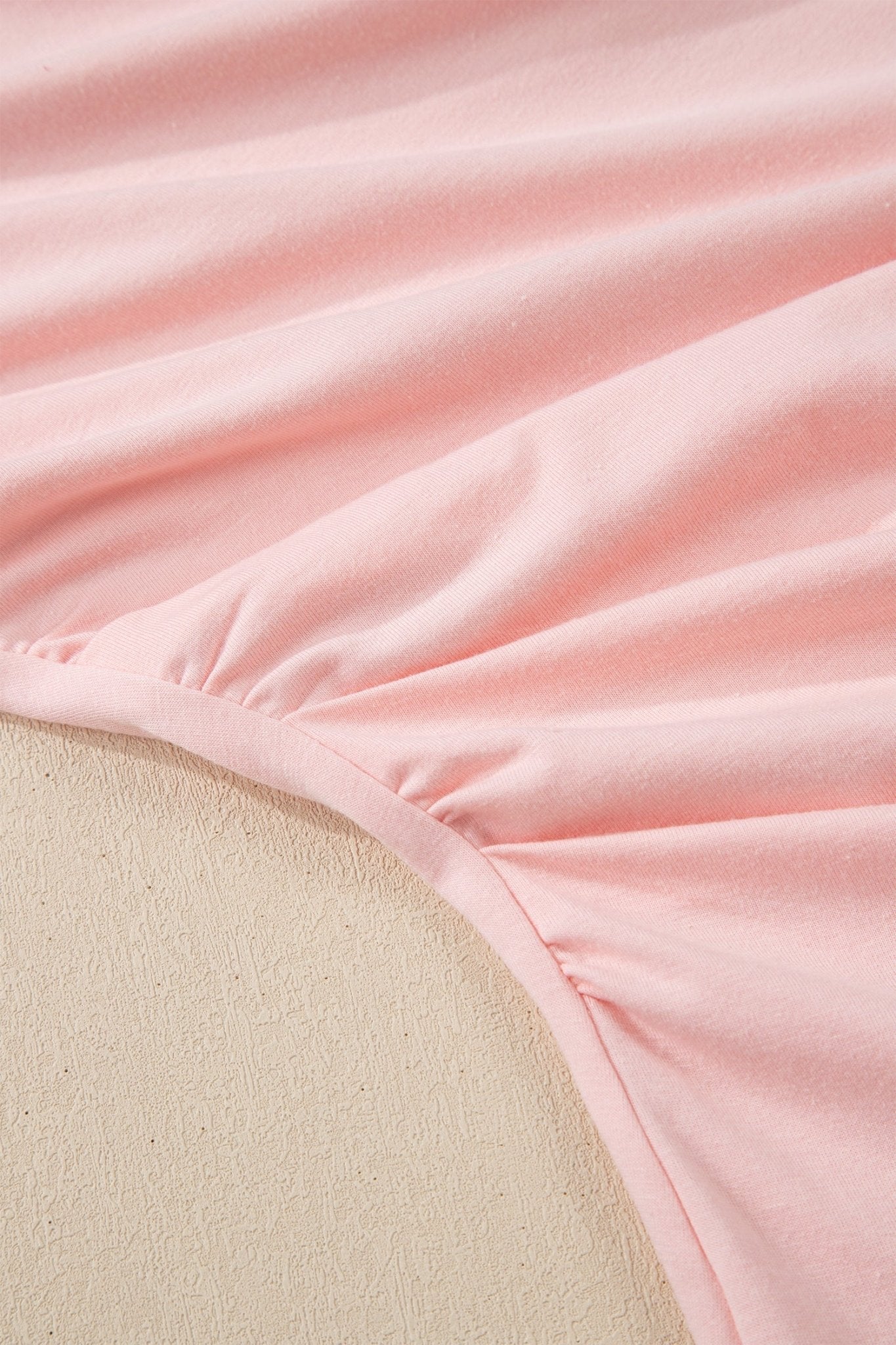 Close-up of pink fabric with a textured surface