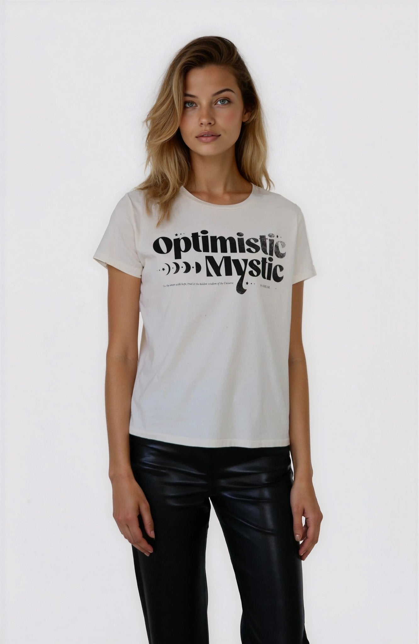 Woman wearing a white t-shirt with 'optimistic Mystic' text on a plain background