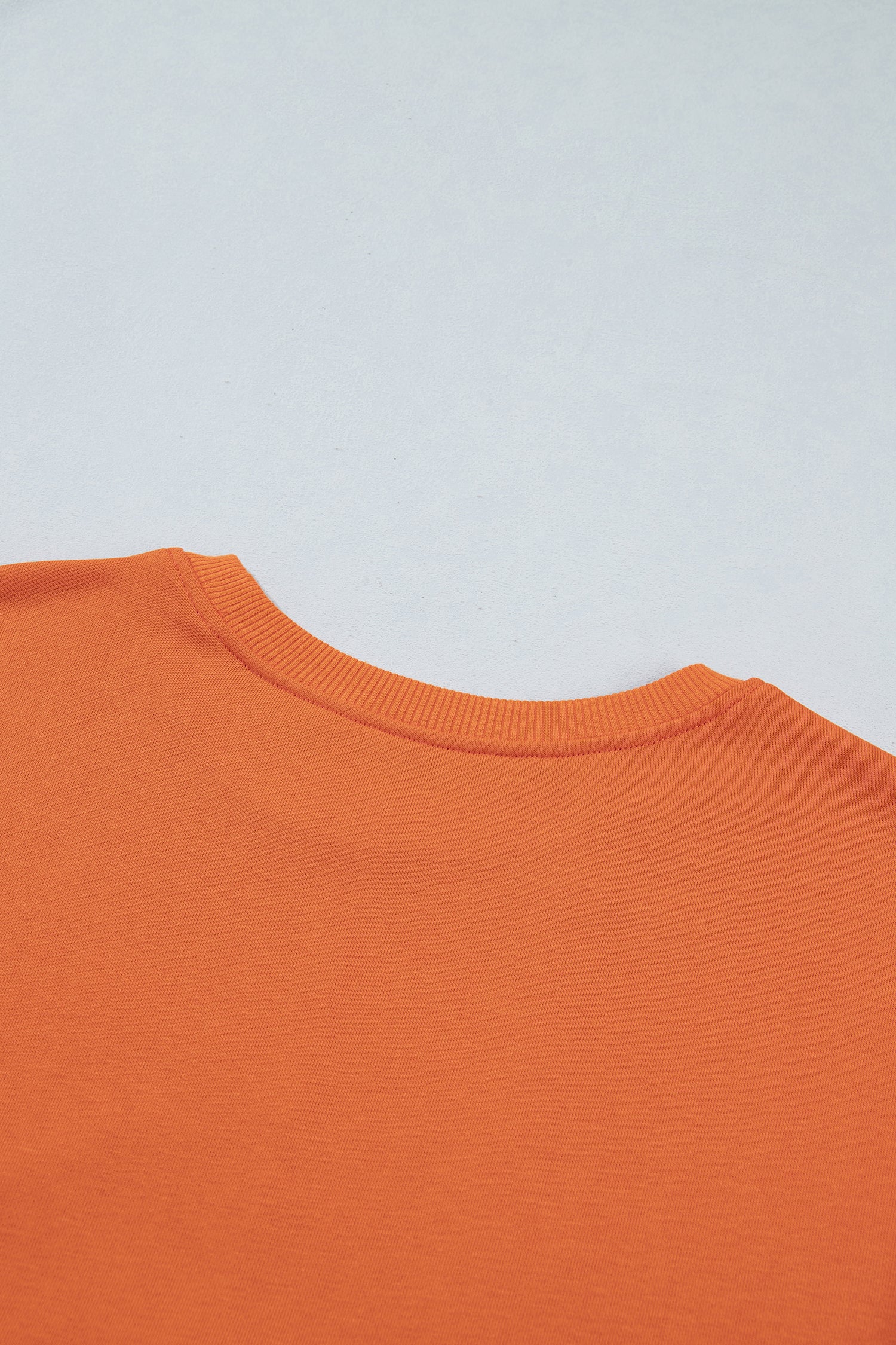 Back neckline detail on orange knit 2-in-1 dress