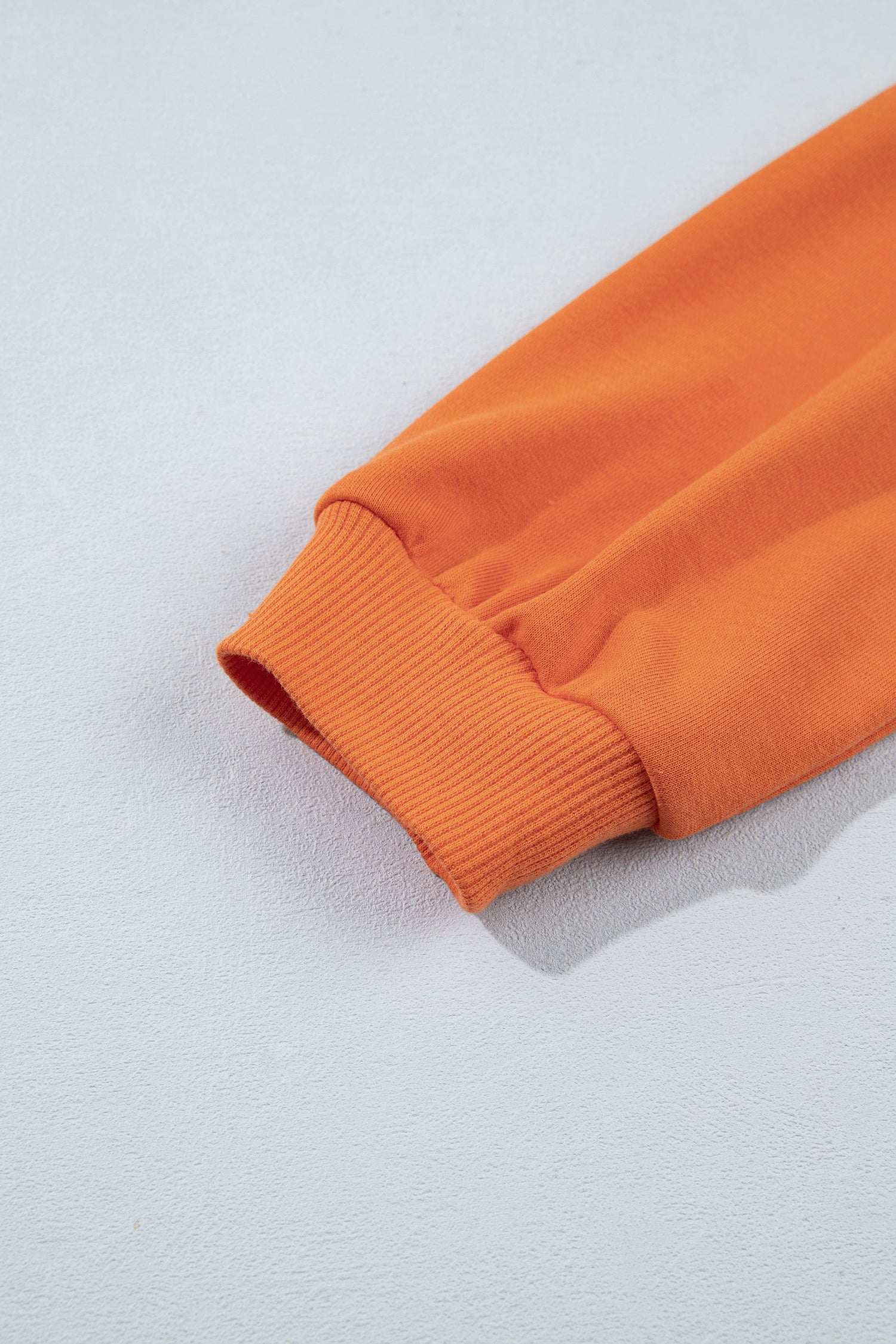 Ribbed sleeve cuff on orange knit 2-in-1 mini dress