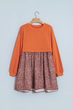 Orange knit top and floral skirt 2-in-1 mini dress on a hanger, front view