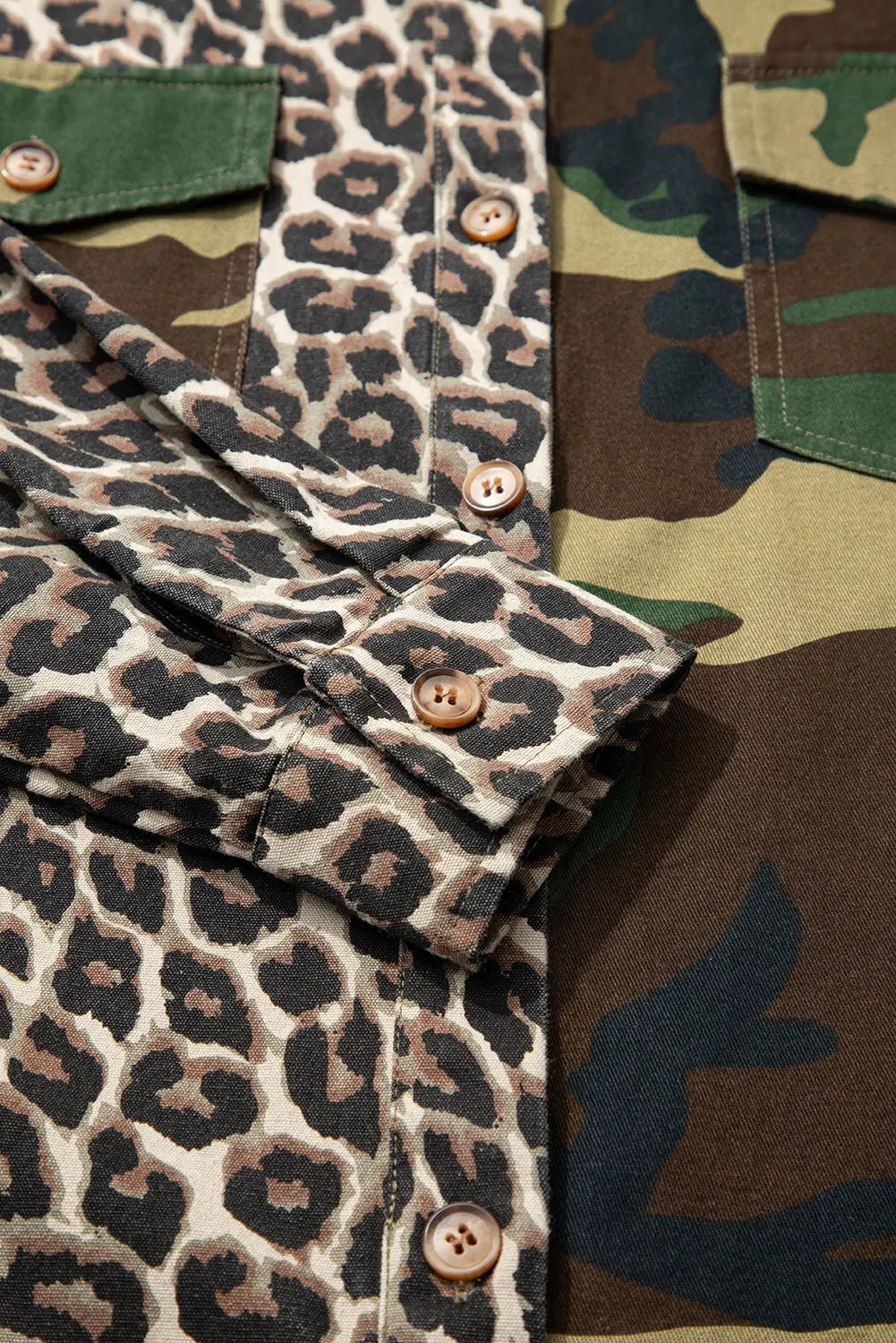 Close-up of a shirt with leopard print and camouflage pattern.