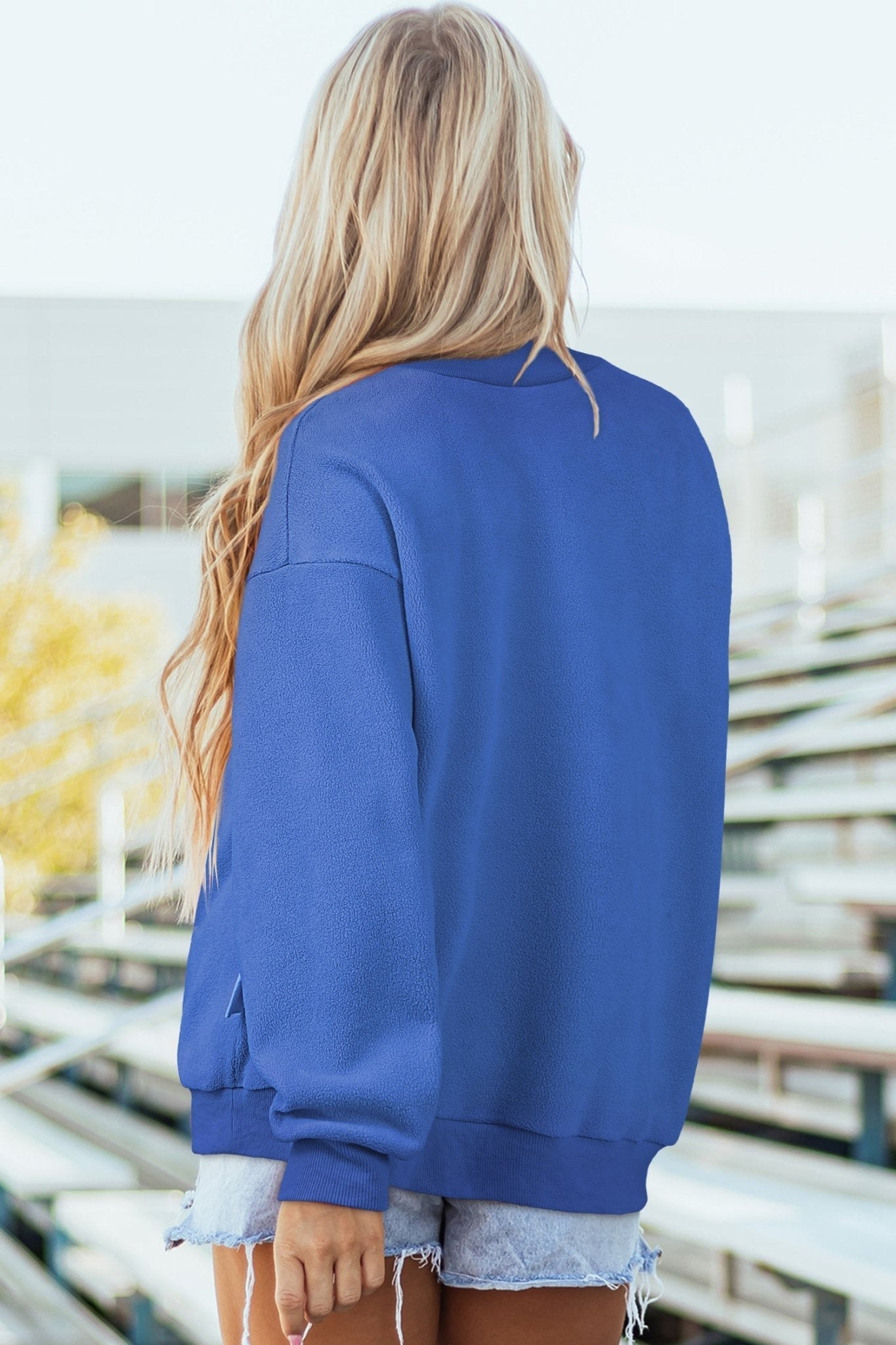 Person wearing a blue jacket with a blurred background