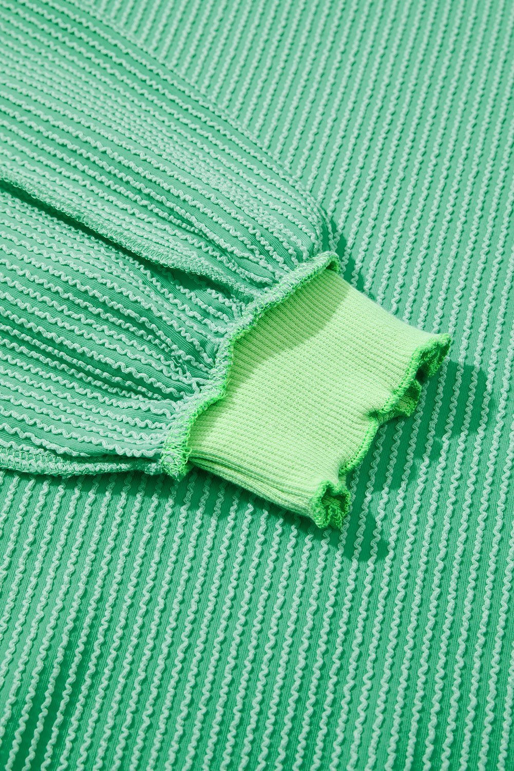 Close-up of green fabric with a textured pattern