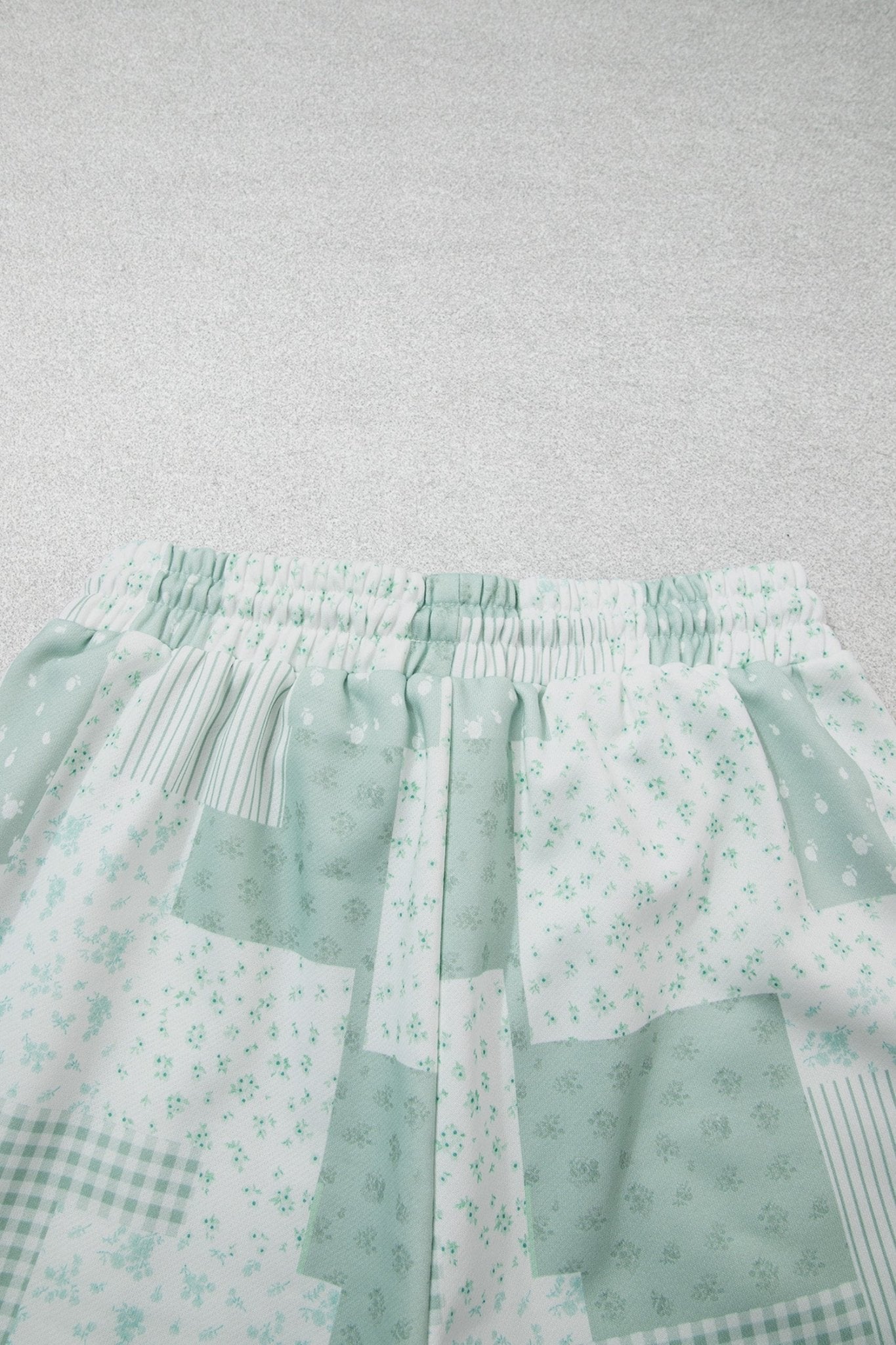 Light green patchwork skirt with floral, gingham, and striped patterns.