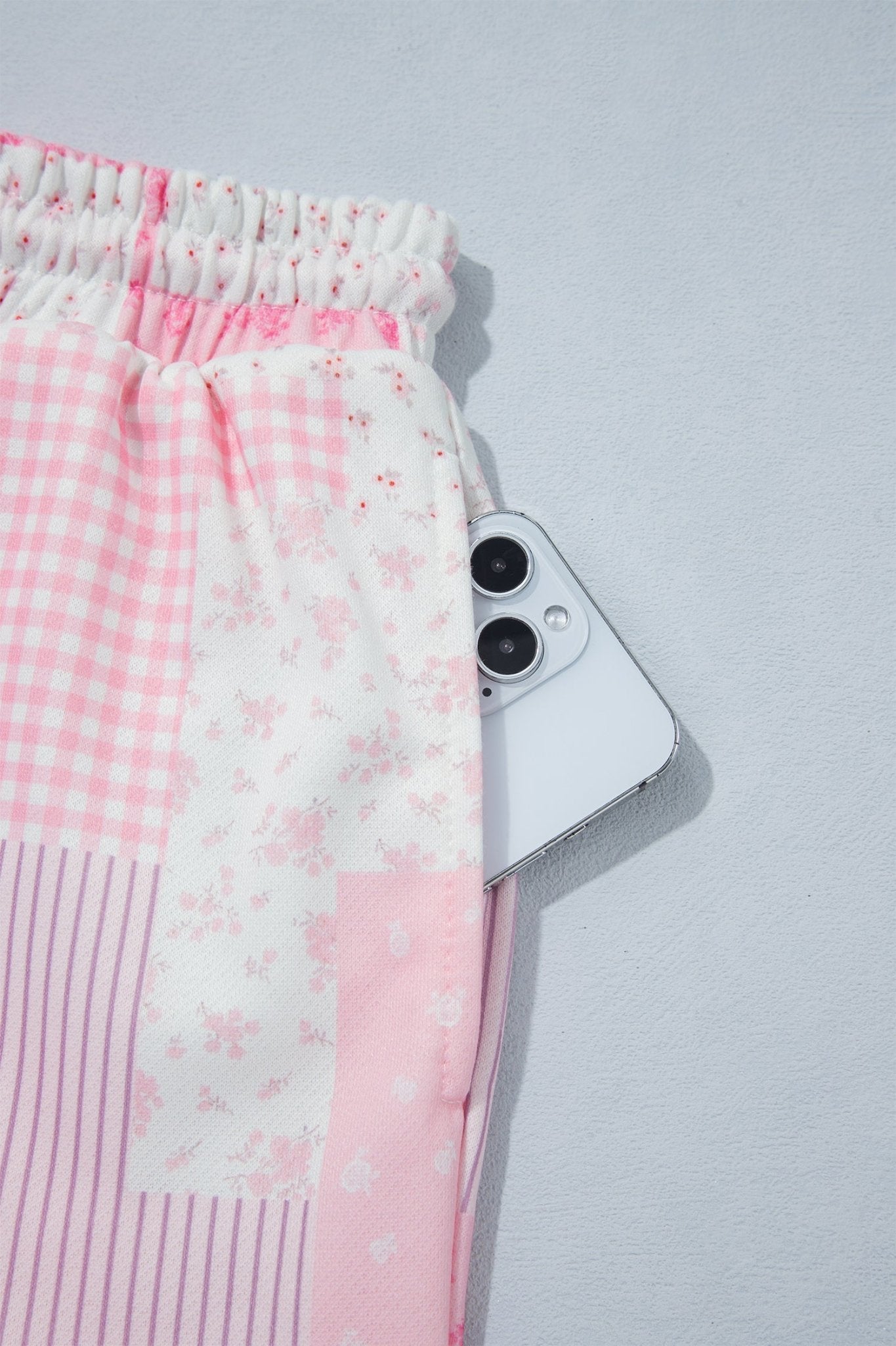 Co-ord pink floral patchwork loungewear featuring a crewneck sweatshirt and matching shorts.