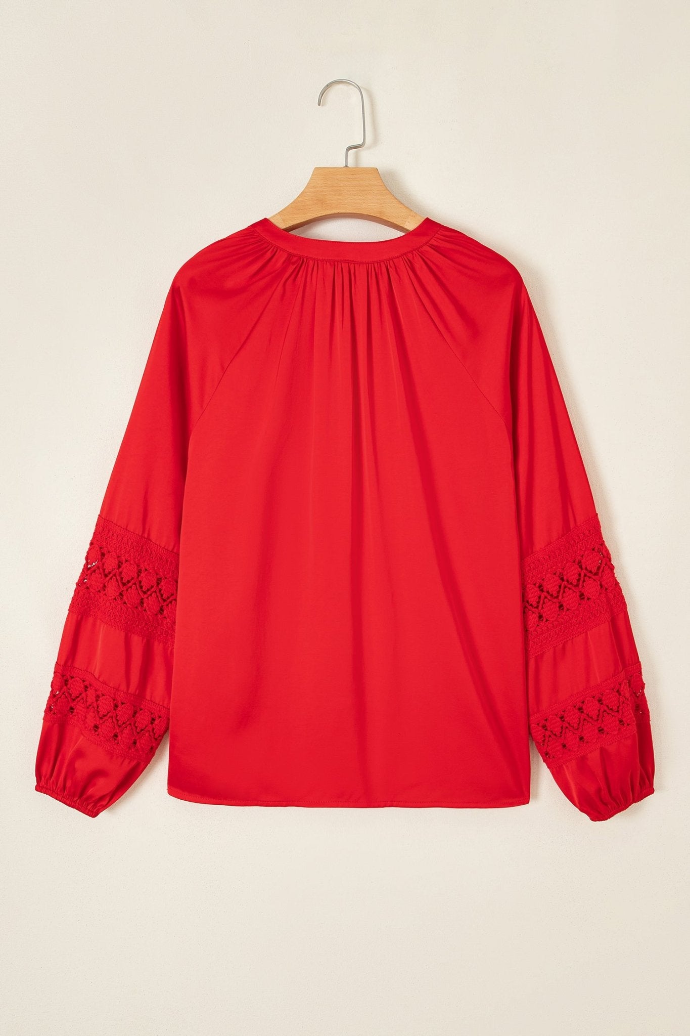Bright red blouse with pleated neckline and black embroidered lace sleev