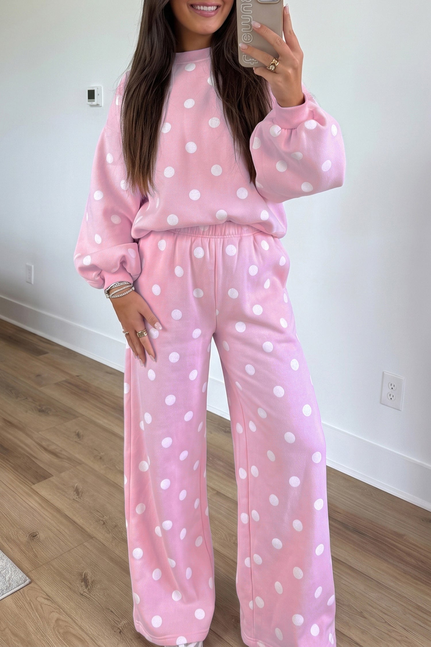 Pink polka dot puff sleeve sweatshirt and wide leg pants set with white dots, front view