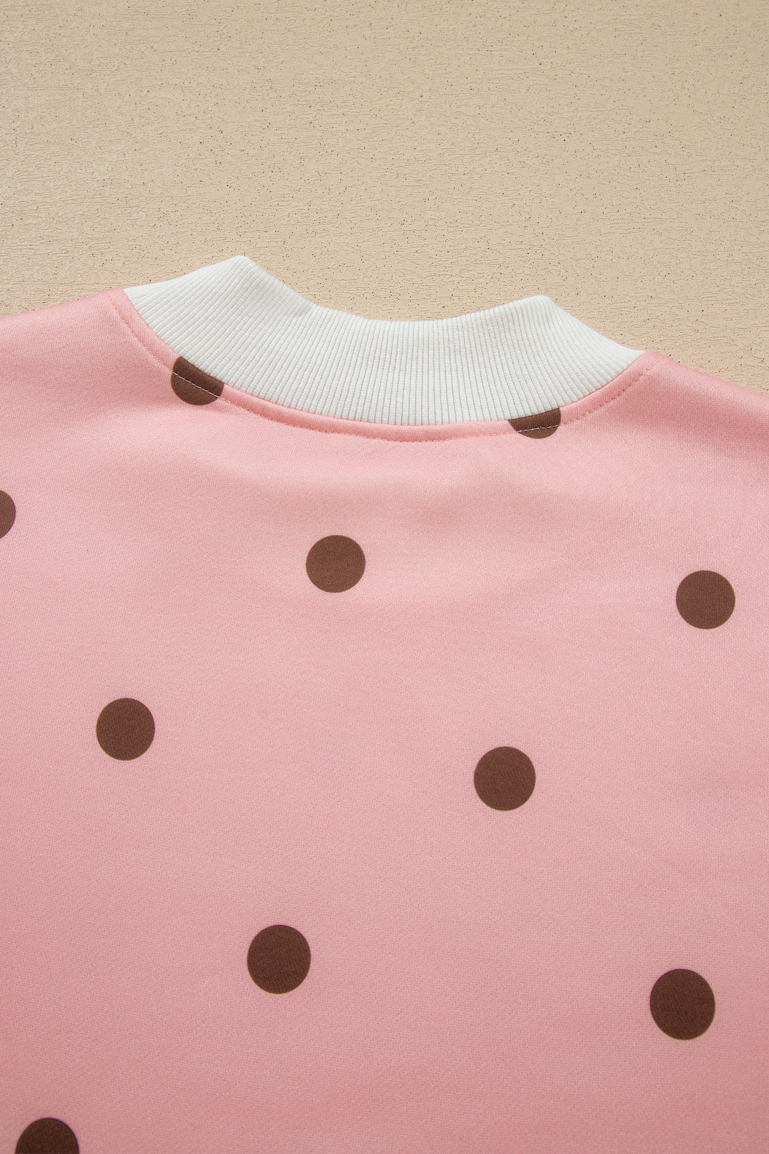 Back ribbed neckline detail on pink polka dot top