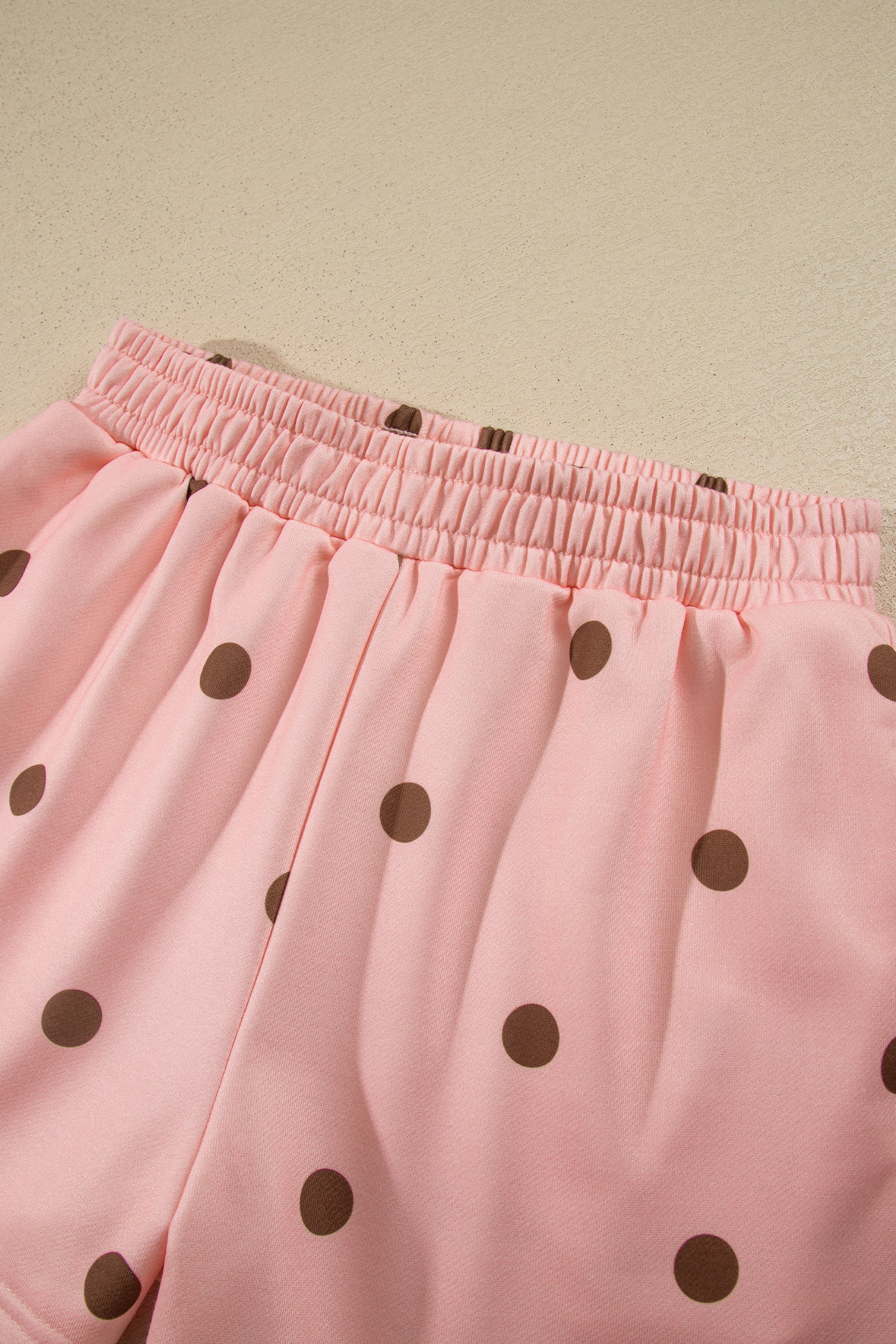 Elastic waistband on pink polka dot shorts, close-up