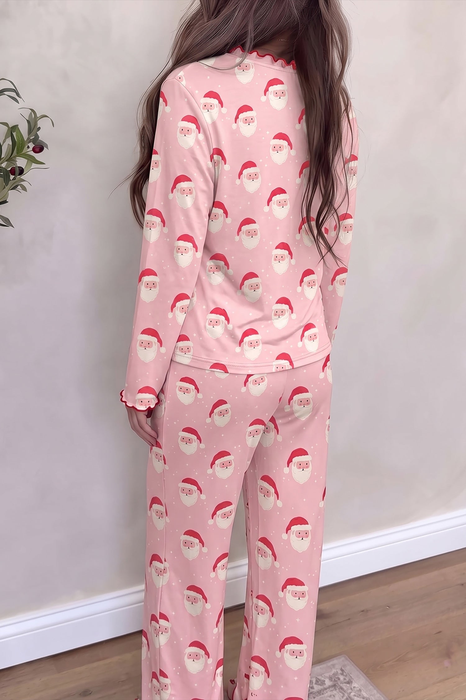 Back view of pink Santa print long sleeve top and wide leg lounge pants set