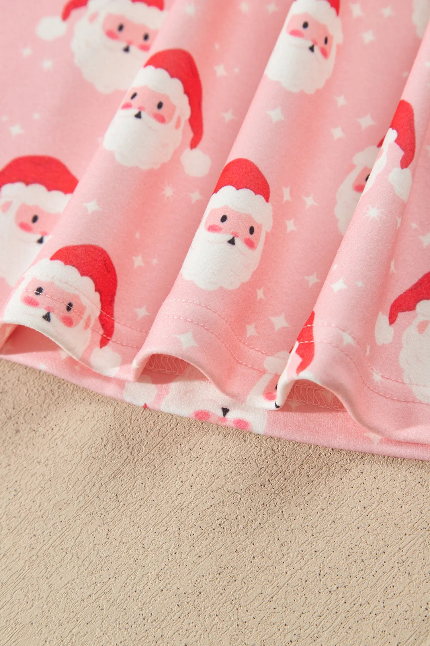 Red lettuce edge trim on pink Santa print Christmas pajama set