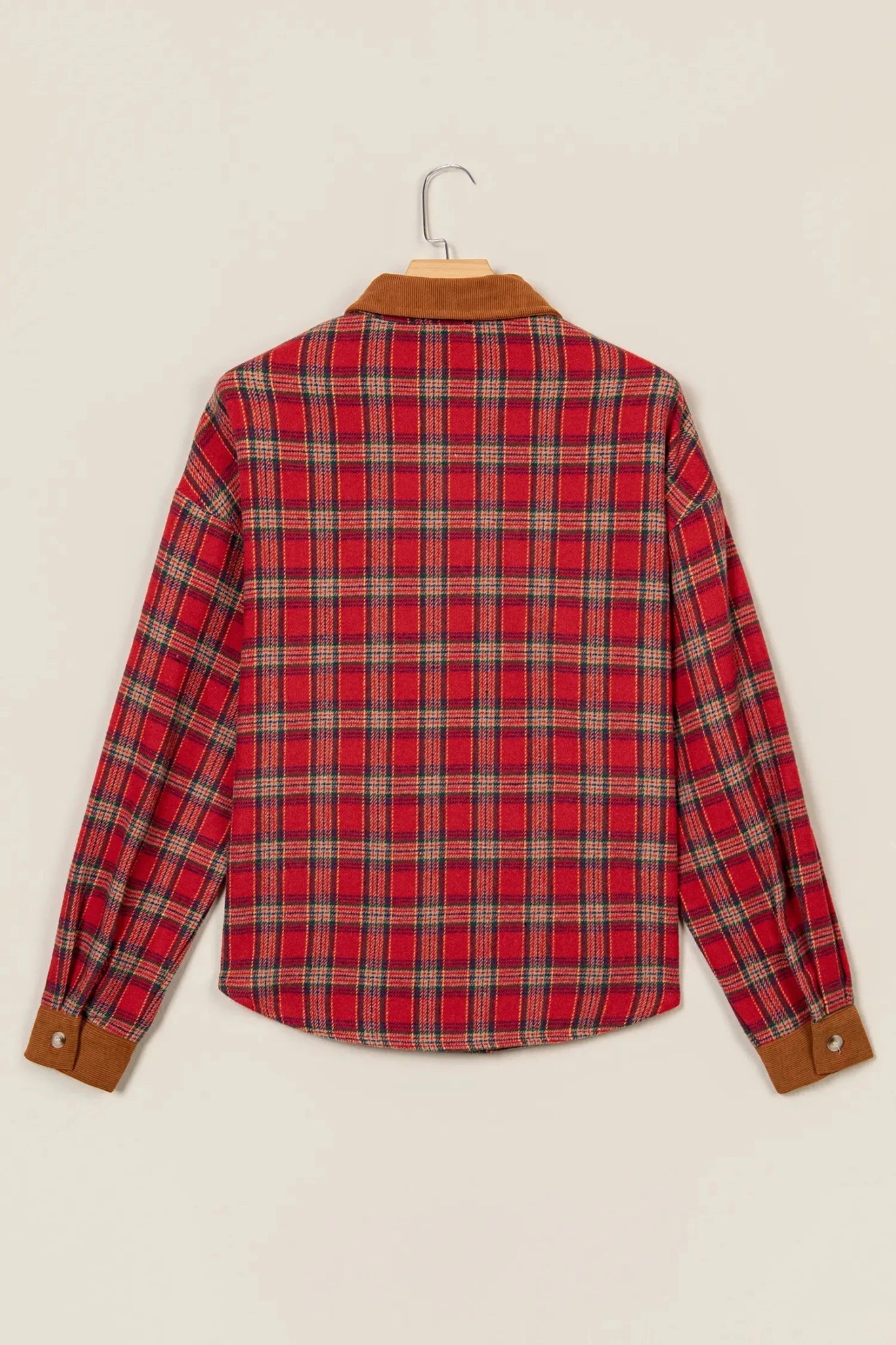 Back view of red-beige plaid button-up shirt on wooden hanger.