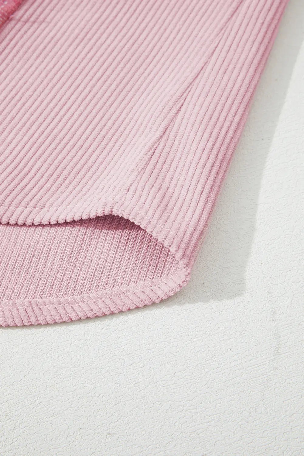 Pink textured fabric on a light gray background