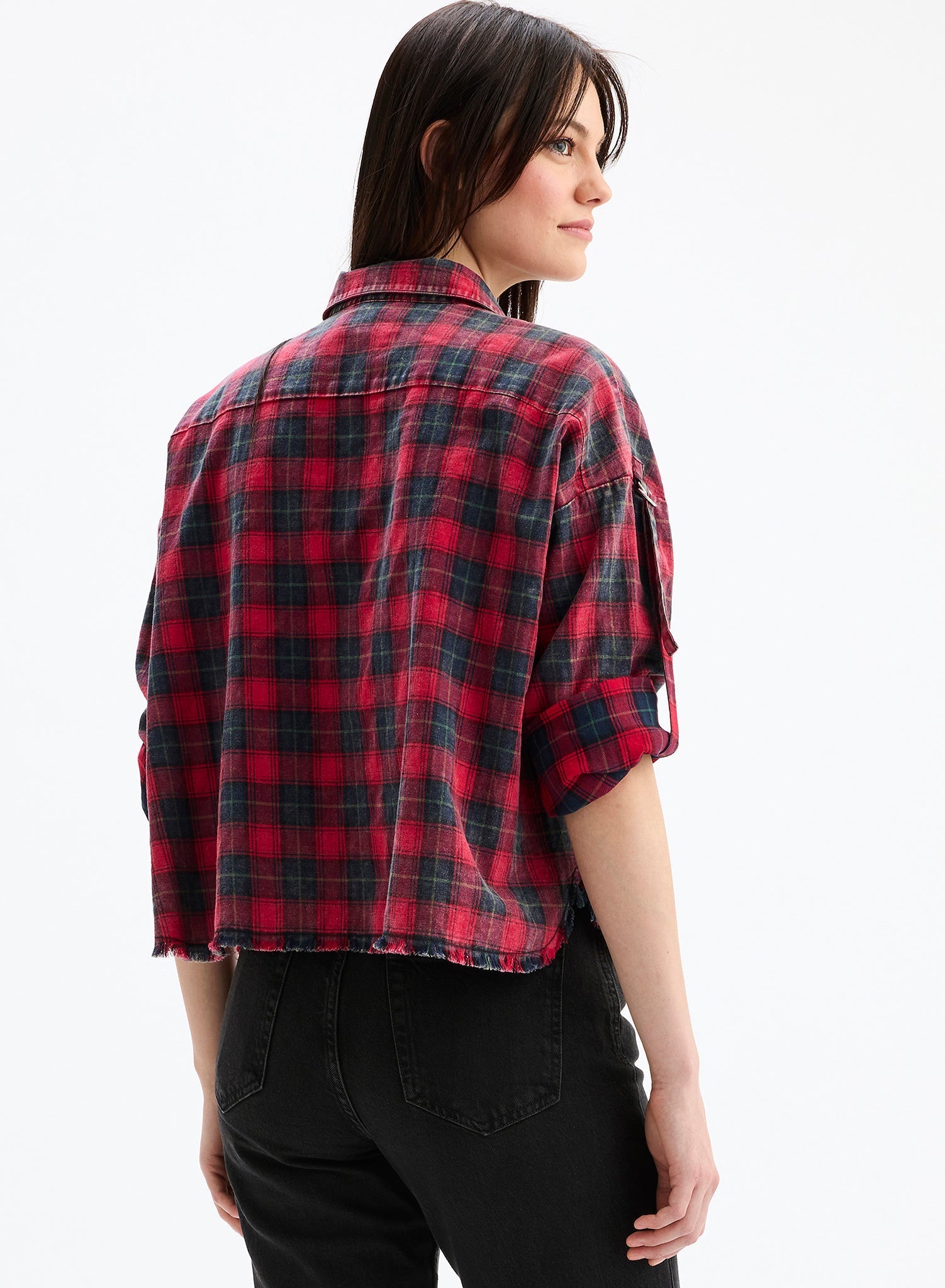 Person wearing a red and black plaid shirt on a white background