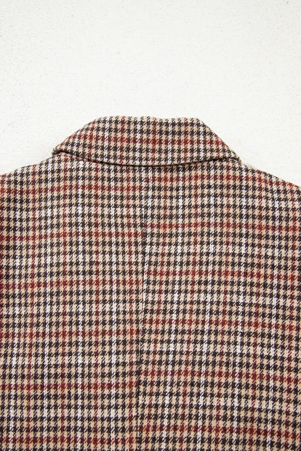 Close-up of a checkered shirt with a collar on a white background
