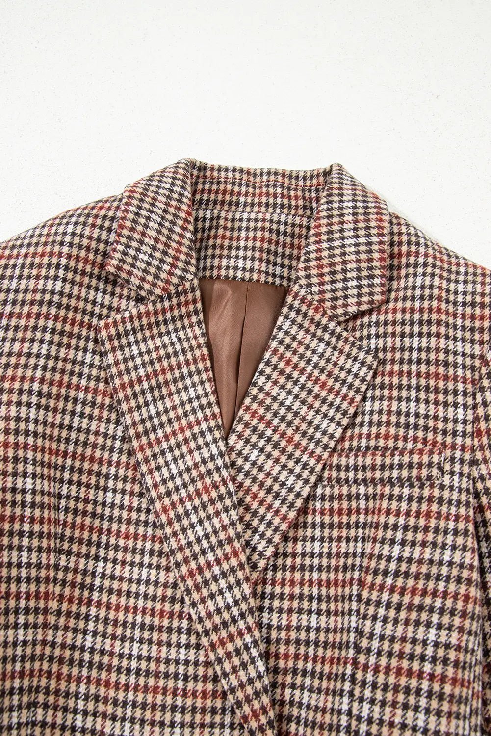 Houndstooth patterned blazer on a light gray background