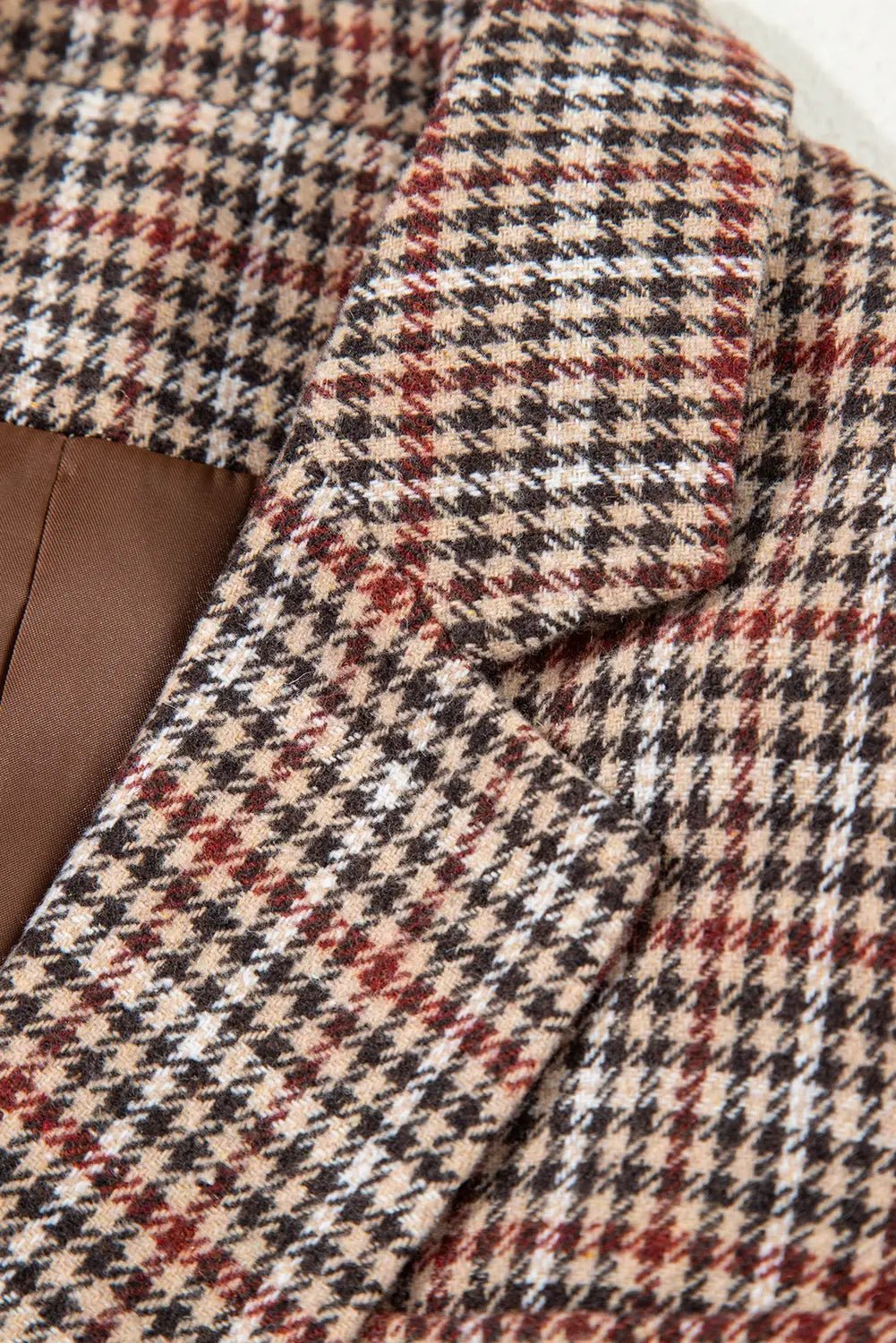 Close-up of a houndstooth patterned fabric with a collar.