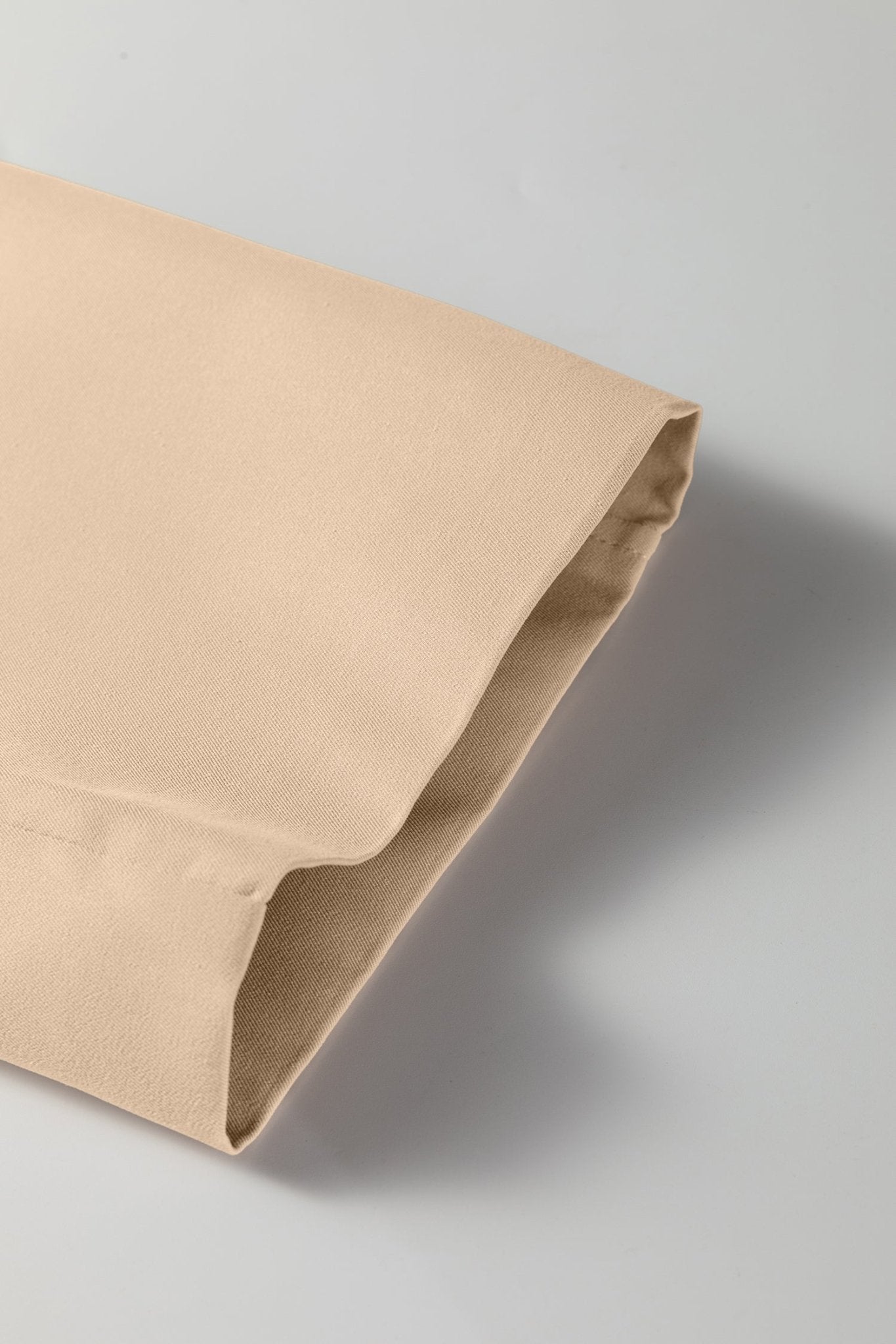 Beige fabric folded on a gray background