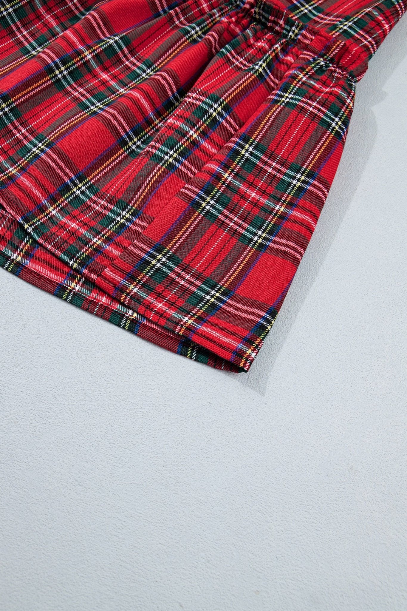 Red tartan plaid fabric with gathered elastic waistband.
