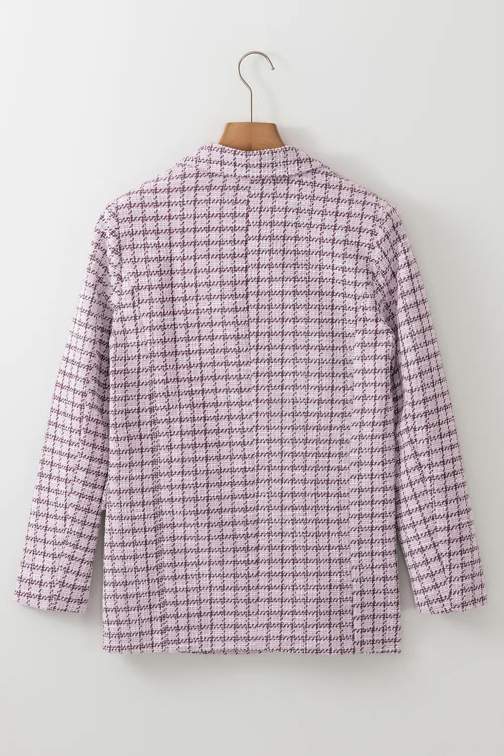 Purple checkered shirt on a hanger against a white background