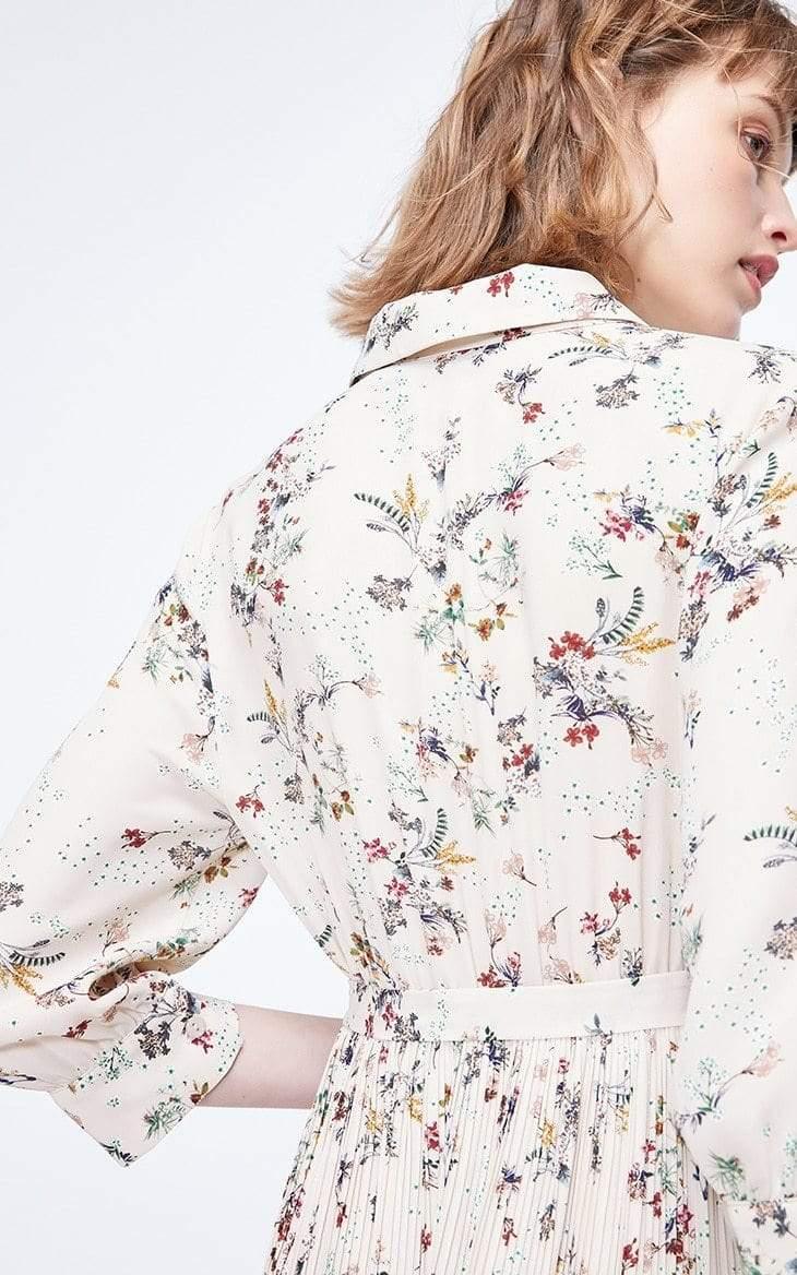 Woman wearing a floral dress with a white background