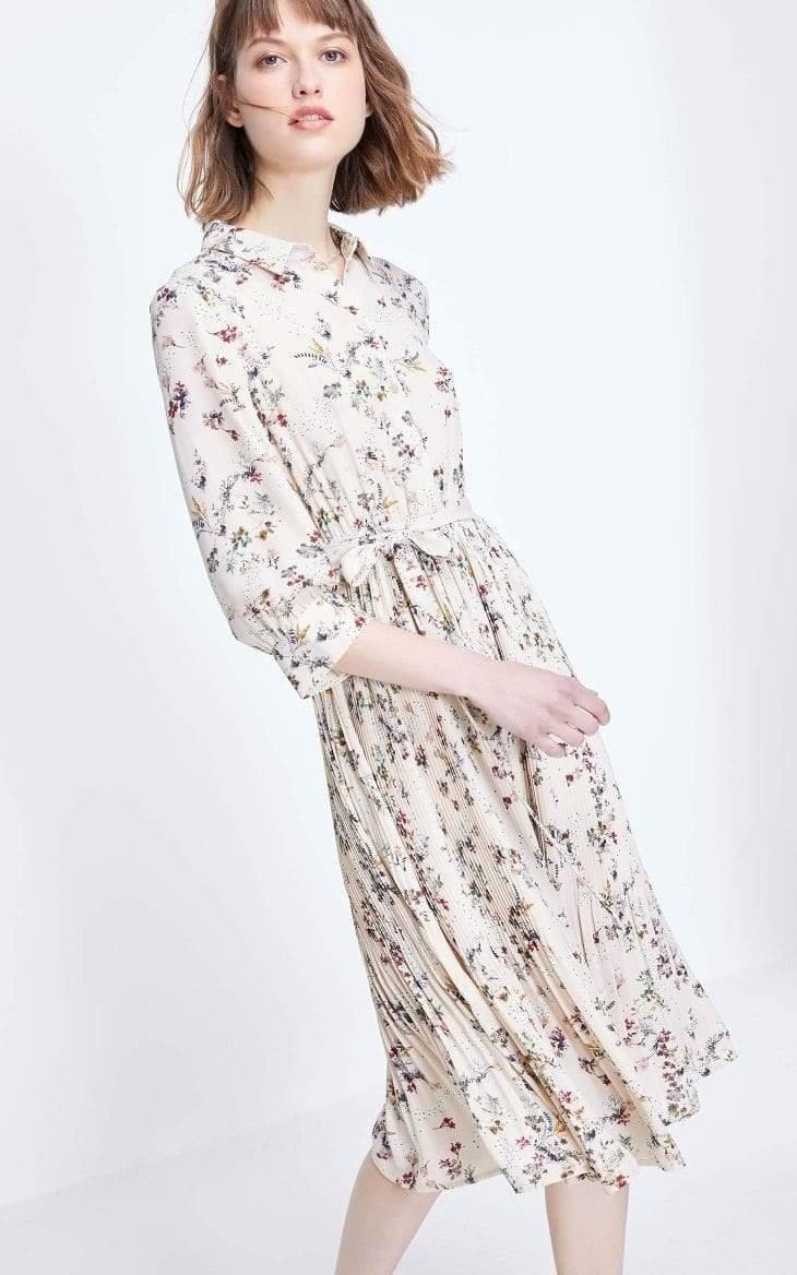 Woman wearing a floral dress on a white background