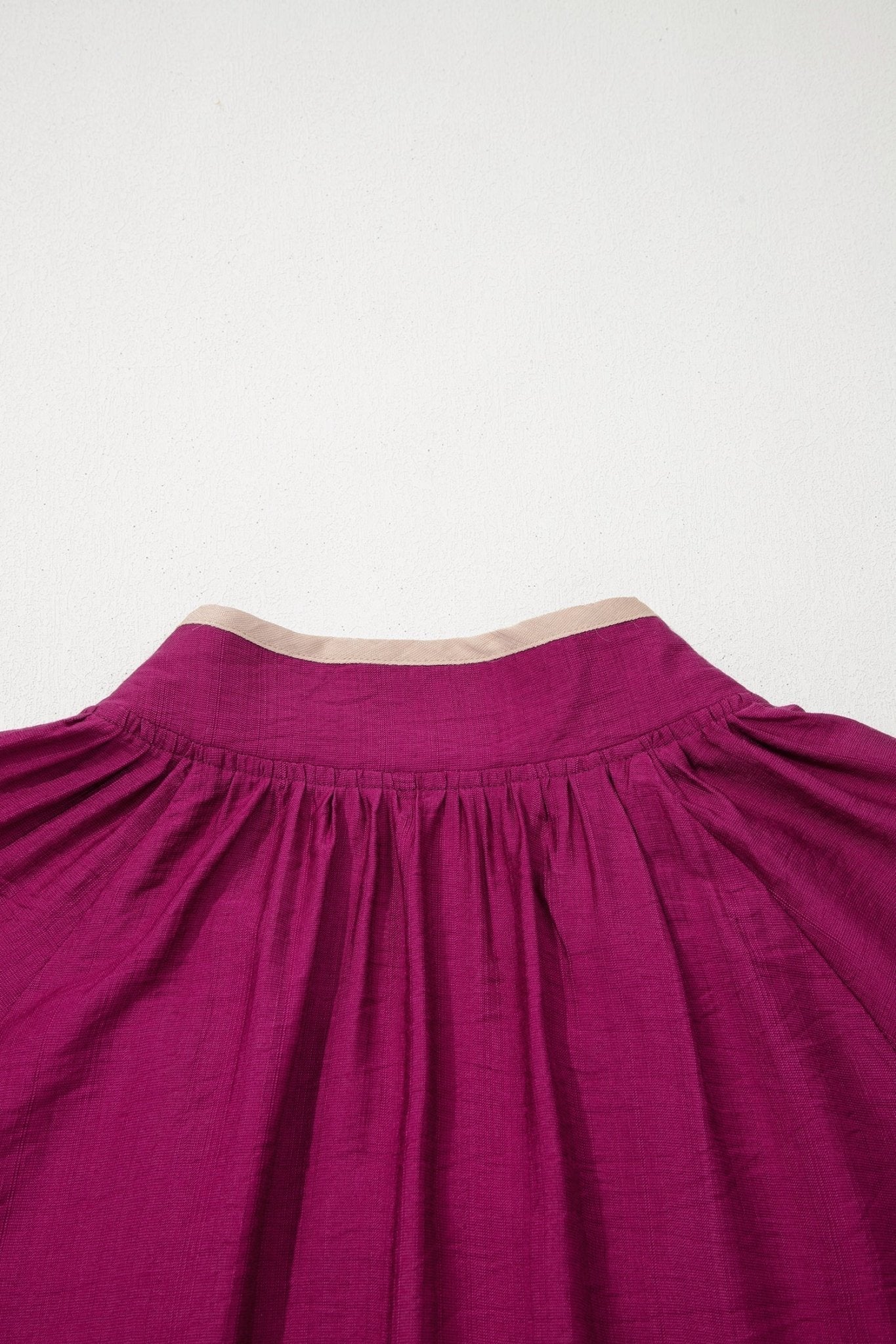Close-up of a magenta fabric with a white background