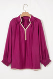 Purple blouse on a wooden hanger against a white background