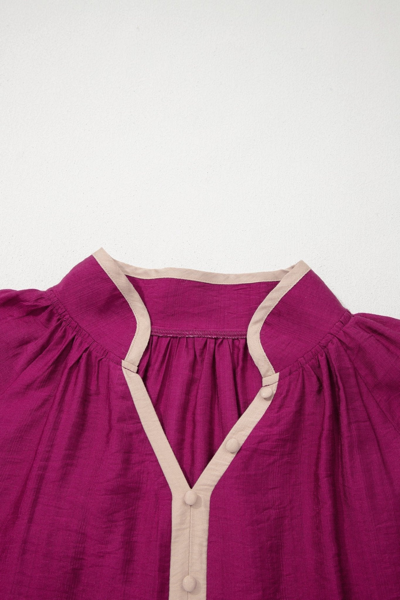 Purple dress with beige straps on a white background