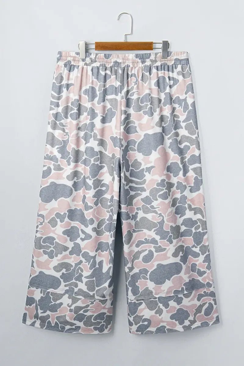 Pink, gray, and white camouflage cropped wide-leg pants with elastic waistband.