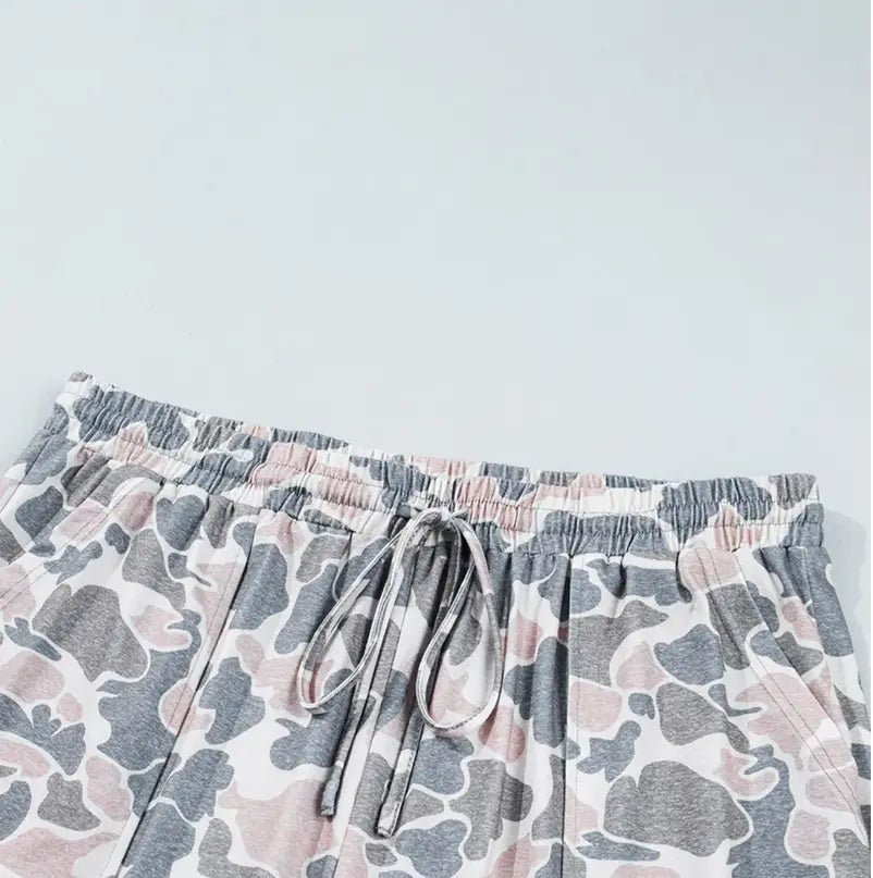Gray, pink, and white abstract camouflage shorts with elastic drawstring waist.