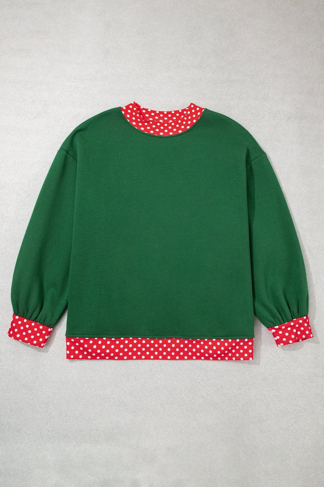 Green long-sleeve crewneck sweatshirt with red-white polka-dot trim on collar, cuffs, and hem, flat on light gray.