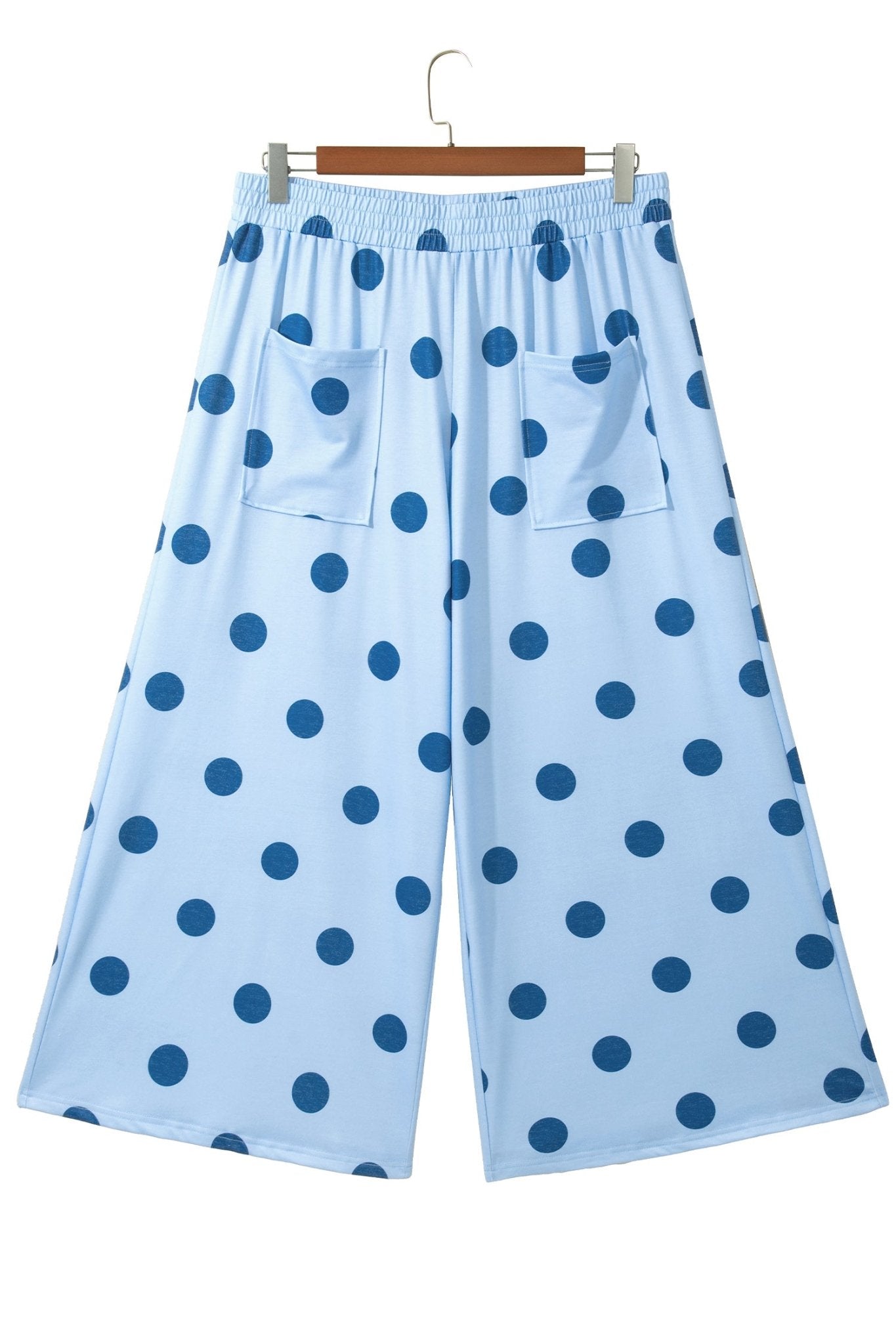 Light blue cropped wide-leg polka-dot pants with patch pockets and elastic waistband on a hanger.