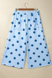 Light blue cropped wide-leg pants with dark blue polka dots, patch pockets, and elastic waistband.