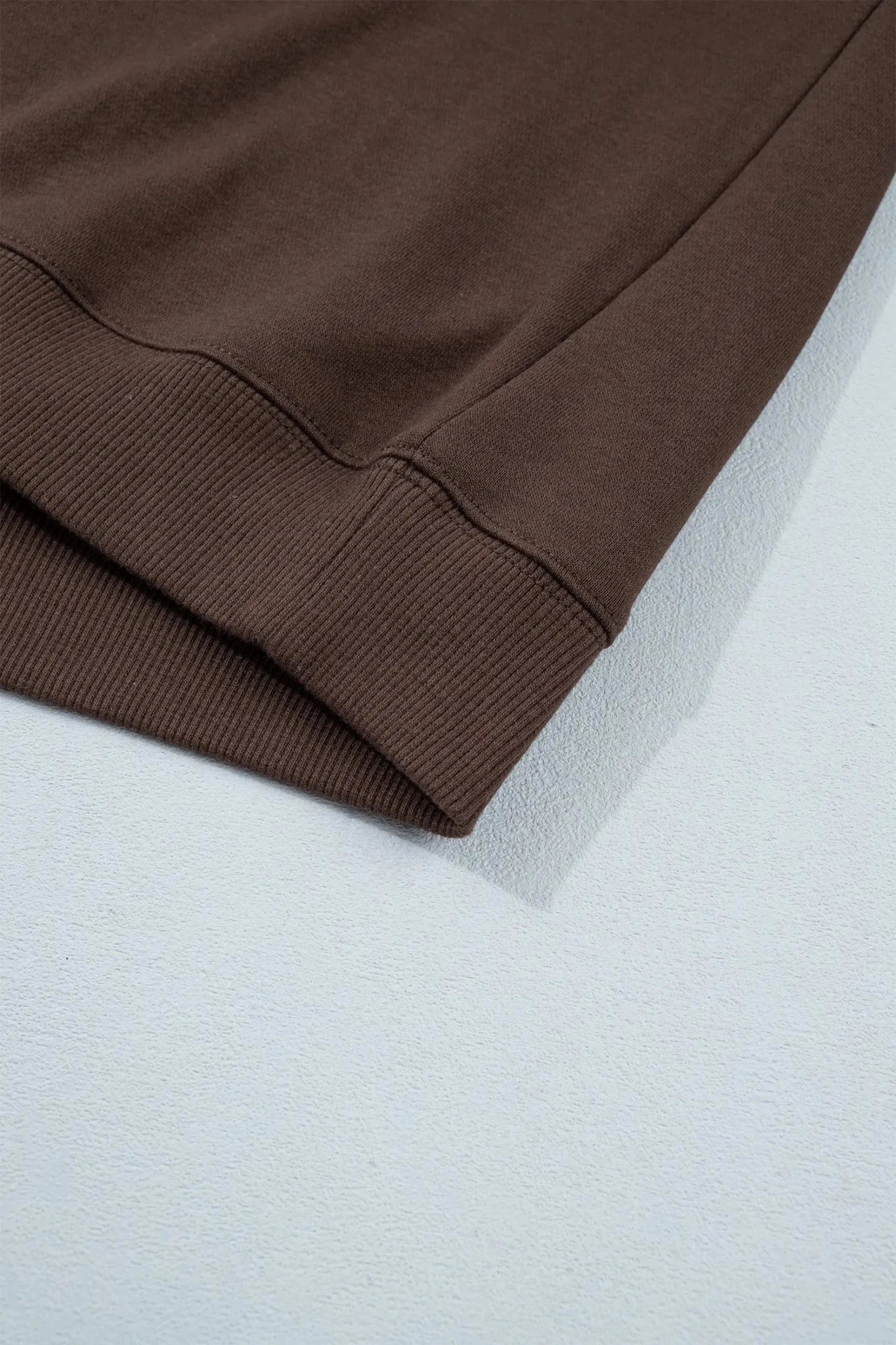 Close-up of black fabric on a textured white surface