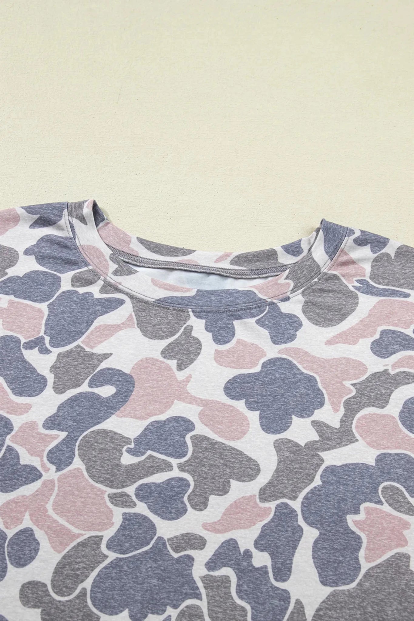 Camouflage-patterned shirt on a beige background