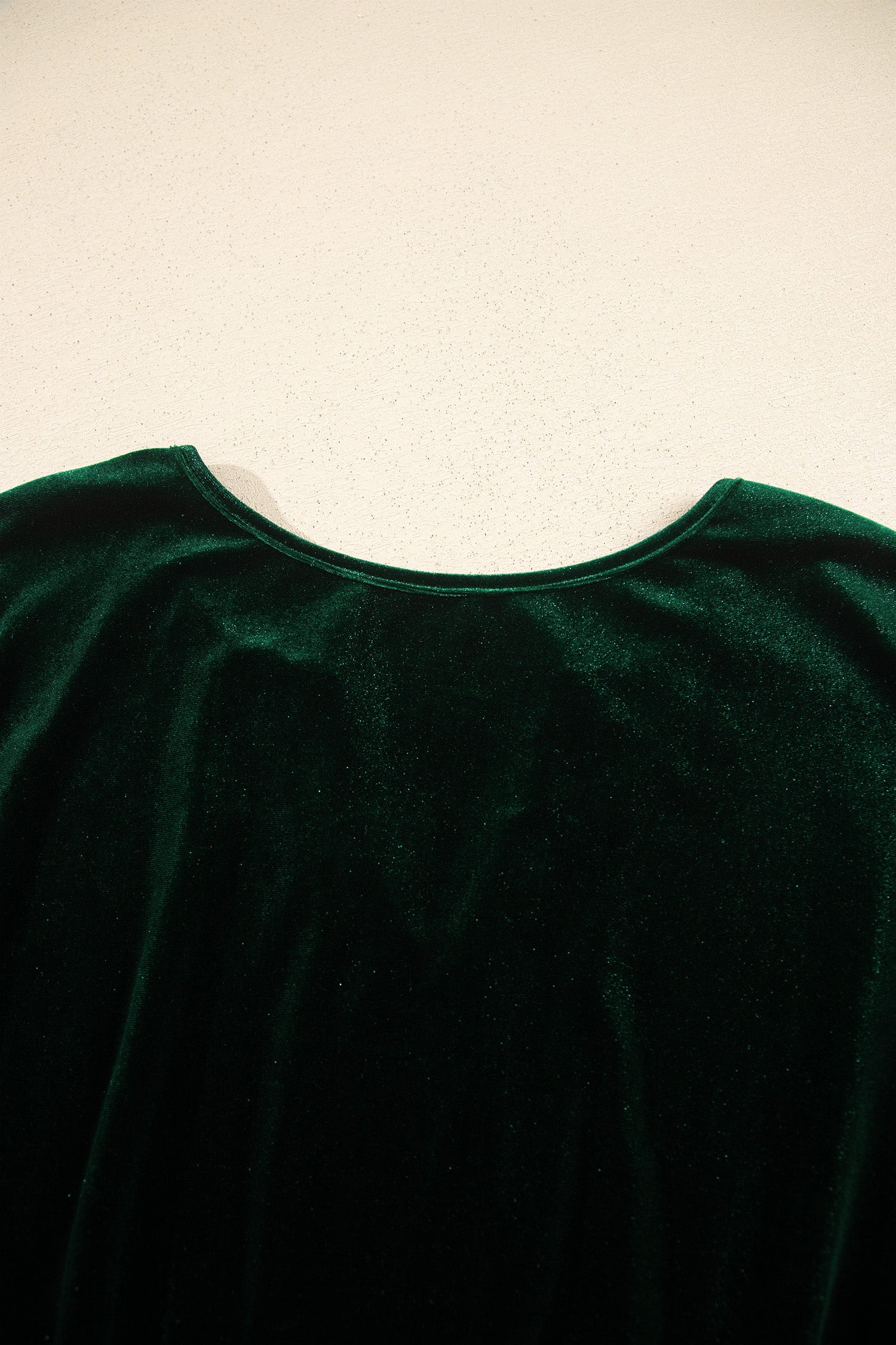 Close-up of back neckline on green velvet maxi dress