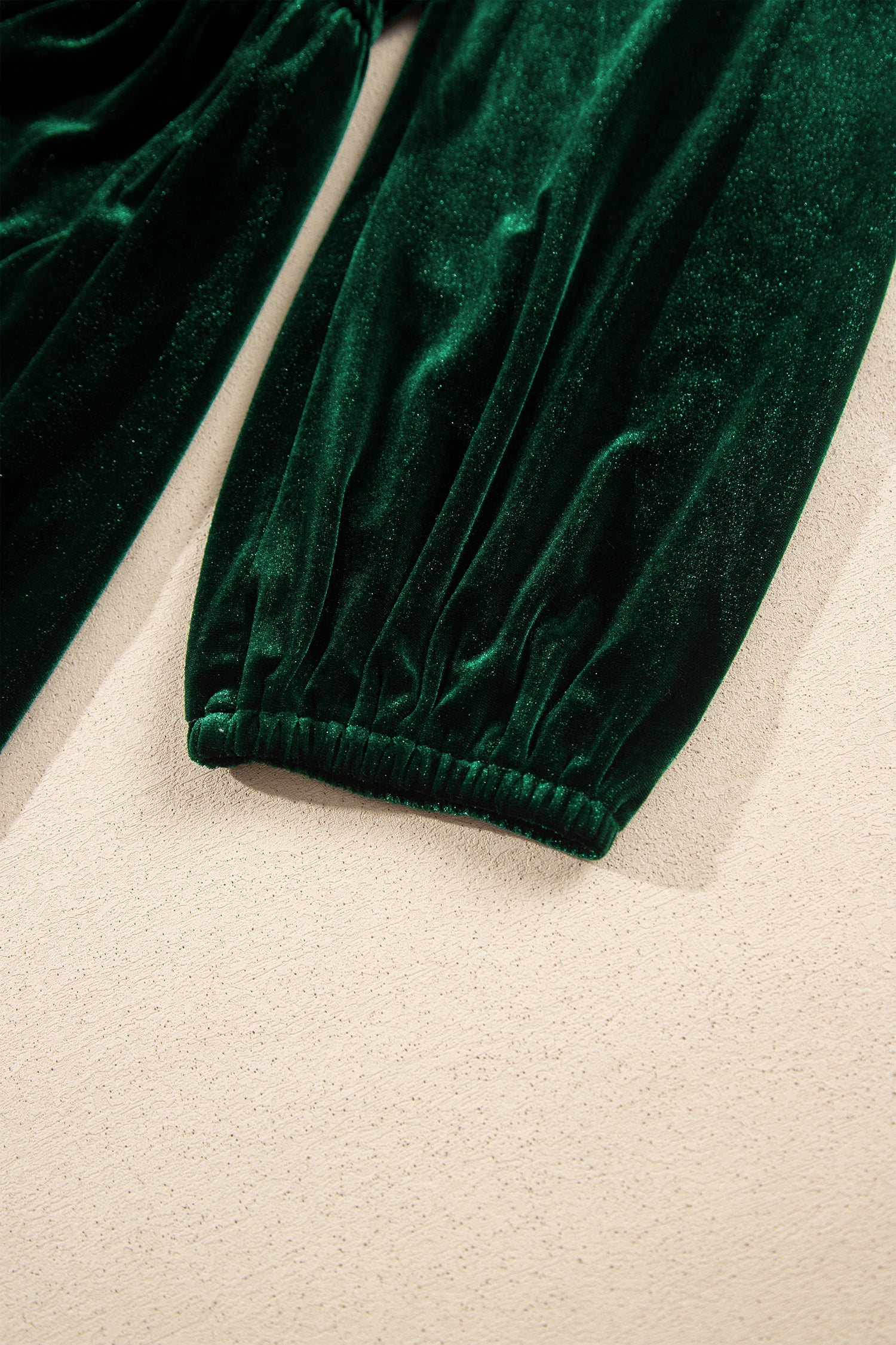 Close-up of elastic cuff on green velvet maxi dress balloon sleeve