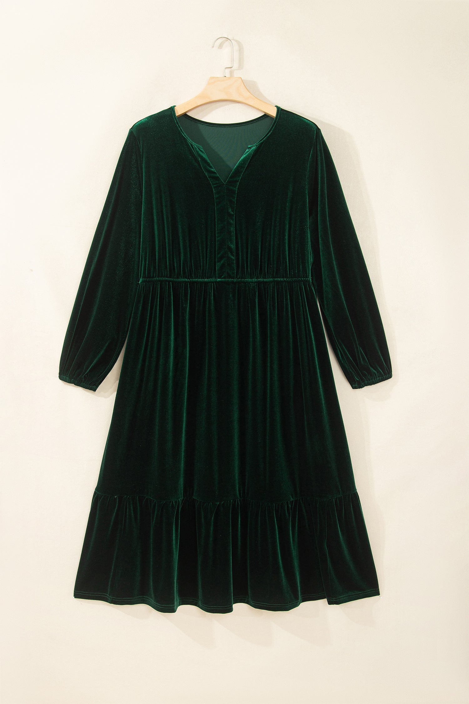Green velvet V neck tiered maxi dress with long sleeves on a hanger, front view